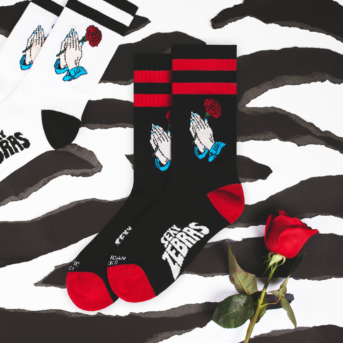 Black and red crew socks with hands holding a rose flower with white and black version on the side american socks