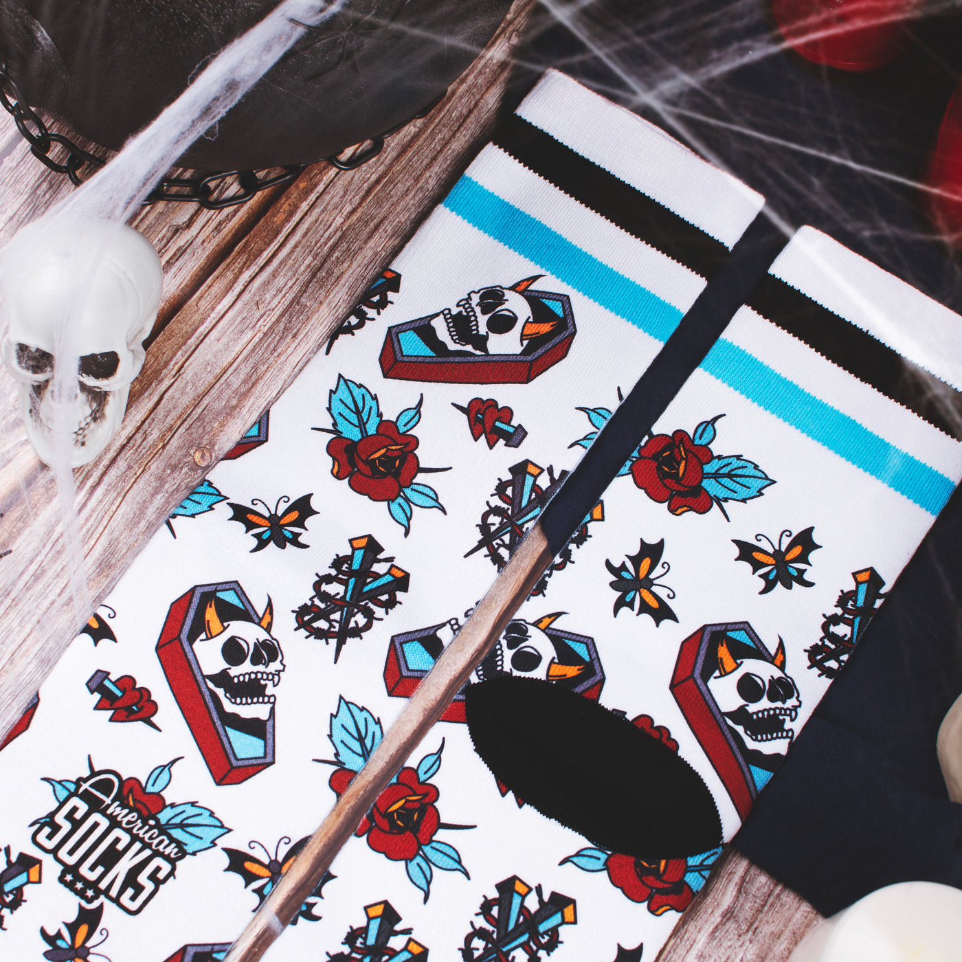 Close up of bold colorful tattoo socks with grave skull roses and barbed wire design american socks