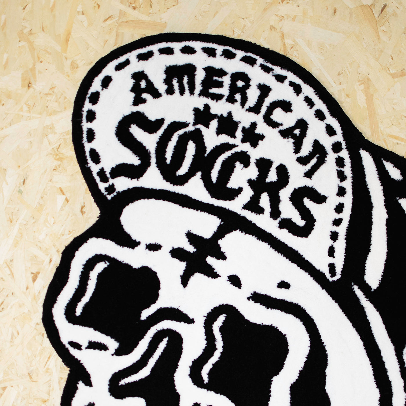 Close up of cool punk rock rug with black and white skull wearing a cap  design american socks 