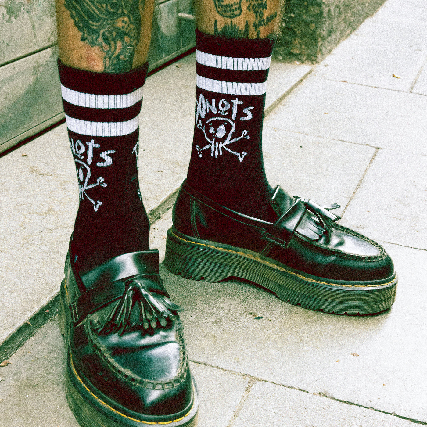Black socks with skull doodle and edgy 'donots' text punk style american socks