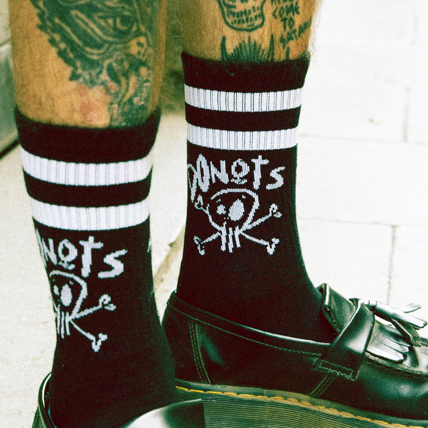 Black socks with skull doodle and edgy 'donots' text punk style american socks